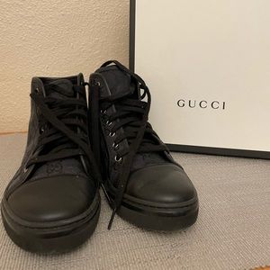 Black high top  Gucci fabric sneakers.